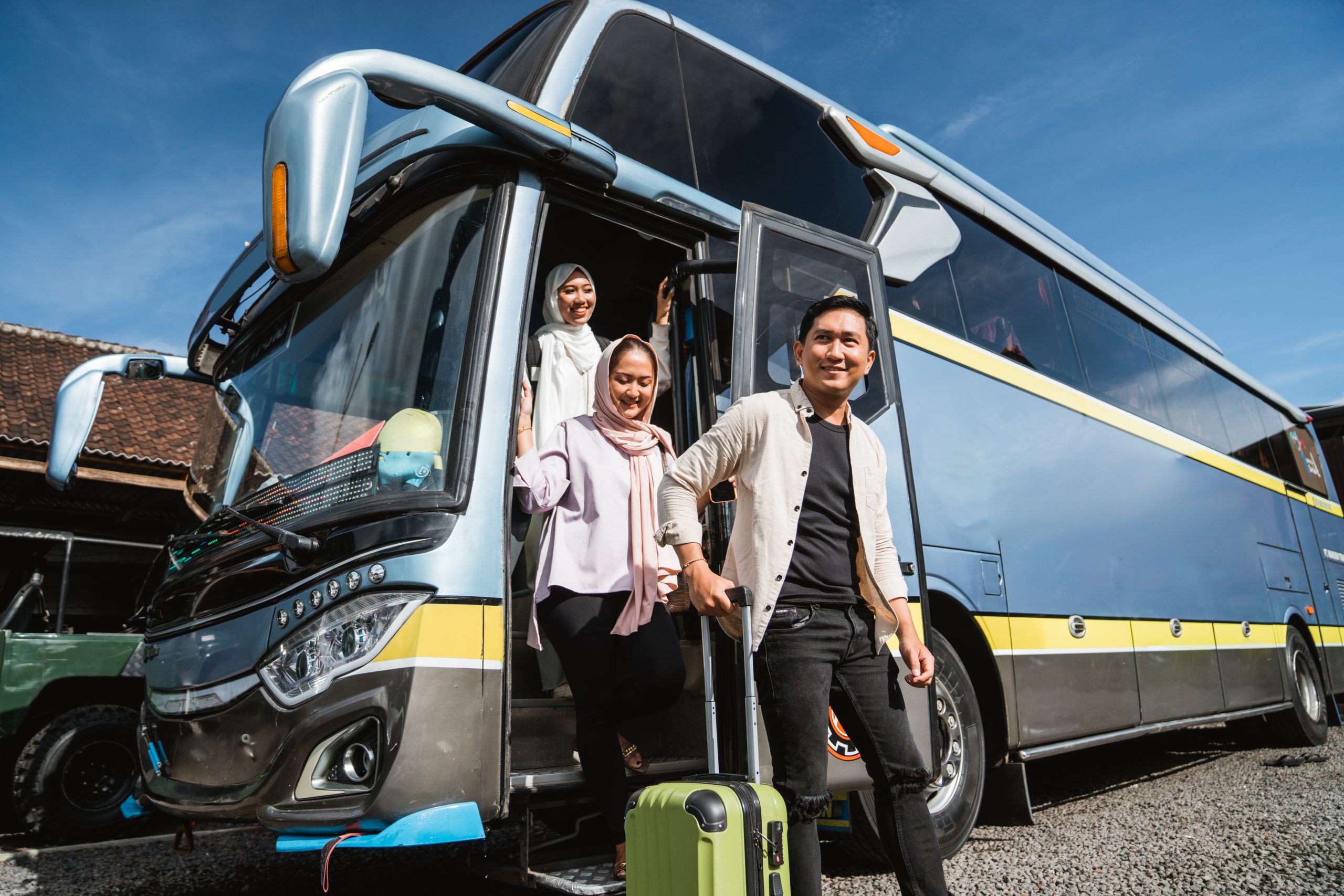 happy asian muslim passengers lined up in line to get off the bus