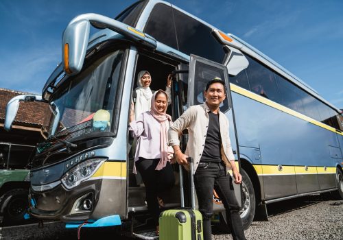 happy asian muslim passengers lined up in line to get off the bus